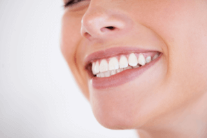 woman with straight teeth after getting Invisalign at 19 wimpole st dental practice in London