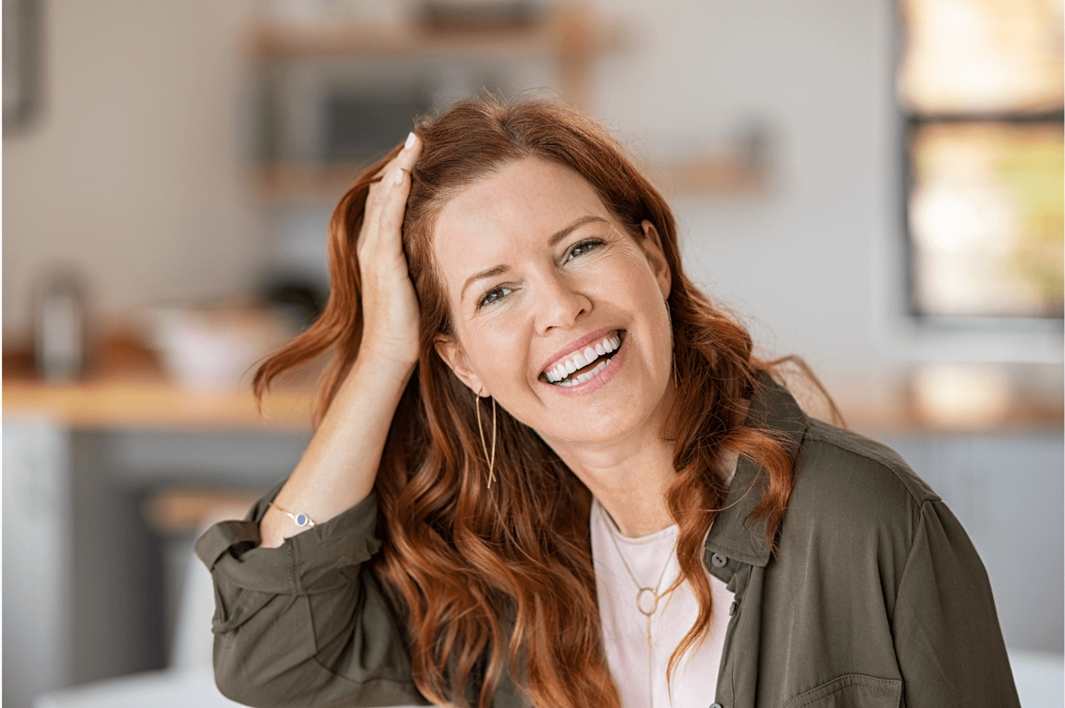 Woman wearing Invisalign braces smiling at the camera